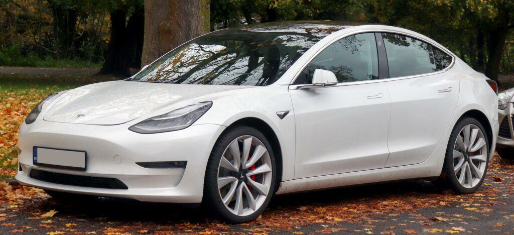 a white tesla model s electric car parked in a parking lot - File:2019 Tesla Model 3 Performance AWD